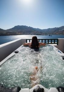 a woman is in a hot tub on a boat at Astrio Suites in Livadi