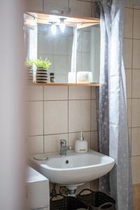 a bathroom with a sink and a shower curtain at Haris apartment 2 in Heraklio
