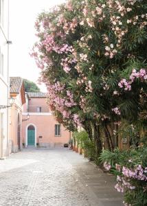 a hedge of flowers on a street at Antica Dimora Le Misure in Cervia