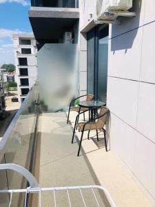 a balcony with a table and chairs on a building at DXN Luxury Studio in Năvodari