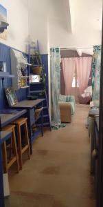a room with blue walls and a room with a table at Bienvenue à la Source dans une Maison de Charme in Apt