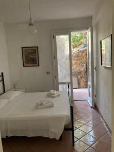 a bedroom with a bed with towels on top of it at Vetrata sul mare in Campese +65 photos