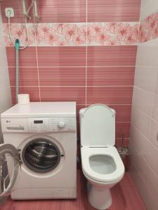 y baño con lavadora y aseo. en Квартира 14 мкр 17 дом на побережье, en Aktau
