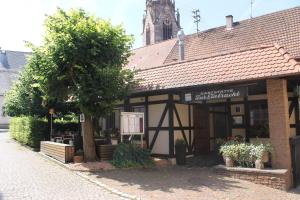 a building with a tree in front of it at Ferienwohnung Herds Eintracht in Baden-Baden