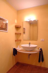 a bathroom with a sink and a mirror at Al Podere Santa Cristina in Castel Maggiore +8 photos