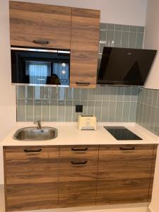 - un comptoir de cuisine avec un évier et un miroir dans l'établissement Mar De Muros, à Muros