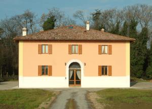 an orange and white house with a door at Al Podere Santa Cristina in Castel Maggiore