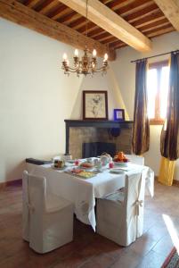 a dining room with a white table and a fireplace at Al Podere Santa Cristina in Castel Maggiore