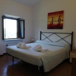 a bedroom with a bed with two towels on it at Rustico Lo Scarpone in Camaiore +40 photos