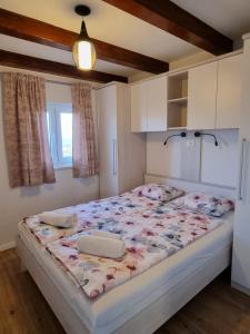 a bedroom with a large bed in a room at Holiday house Adriana in Povljana