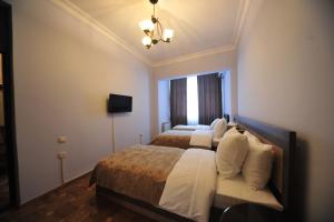 Postel nebo postele na pokoji v ubytování Guest House Batumi Globus