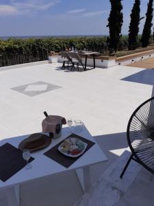 a table with a plate of food on a patio at Villas Lago e Mare in Skála Alykís