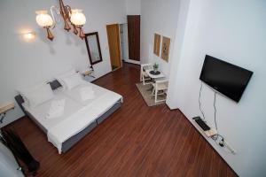 a bedroom with a bed and a flat screen tv at Miro apartments in Mostar