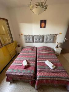 a bedroom with a large bed with two books on it at Auberge Galeris in Galeria