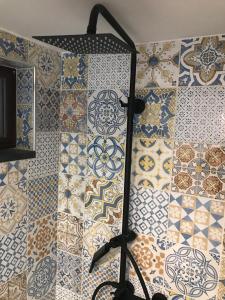 a room with tiles on the wall with a lamp at IL VICOLETTO Luxury Apartments in Augusta +31 photos