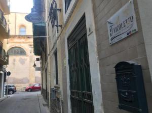 a building with a green door on the side of a street at IL VICOLETTO Luxury Apartments in Augusta
