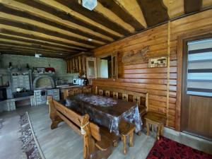 a dining room with a table and a kitchen at near waterfall in Skole
