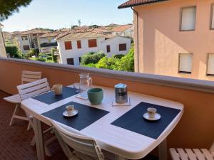 a table on a balcony with two cups of coffee at Casa Selia in Cecina