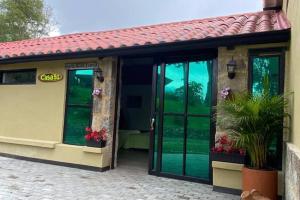 a building with sliding glass doors with a patio at Moderna cabaña en medio de la naturaleza in Santandercito