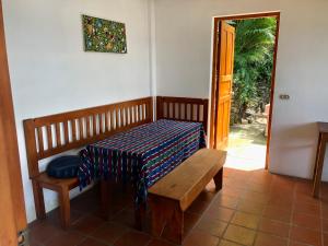 a bench with a blanket on it in a room at Rustic Charm and Breathtaking Views in Santa Cruz La Laguna