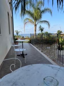a patio with a table and chairs and the ocean at Residenza Azzurra in Tropea