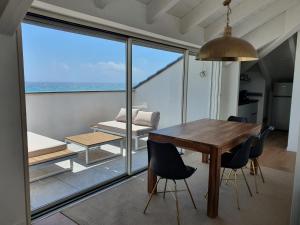 a dining room with a table and a view of the ocean at Blu Sea apartments in Pietra Ligure