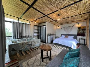 ein Schlafzimmer mit einem Bett und einem Sofa in einem Zimmer in der Unterkunft Santa Helena Iscala in Chinácota