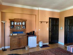 a kitchen with a white refrigerator and a wooden cabinet at Haus Kroneck-Salis Gästeappartement in Bad Iburg