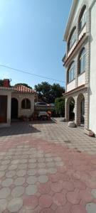 a large building with a brick driveway in front of it at Dexi Rab in Banjol