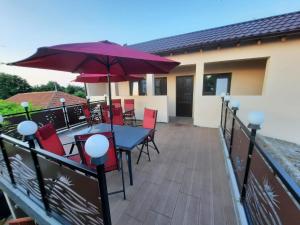 a patio with a table and chairs and an umbrella at Casa Marștef in Eforie Sud
