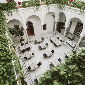 an overhead view of a courtyard with tables and chairs at Palacio Pinello in Seville
