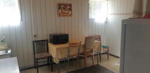 a dining room table with chairs and a television on it at Peipsi Talu Lake view room in Rootsiküla