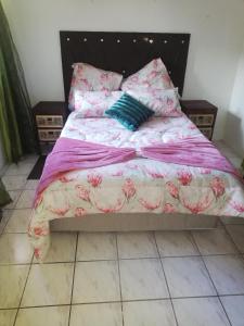 a bedroom with a bed with pink flowers on it at Edward Cabana in Margate