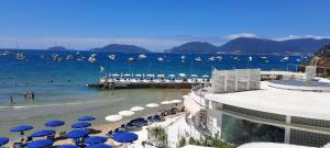 a beach with umbrellas and people in the water at PERLA DEL GOLFO (con Box Auto) in Lerici