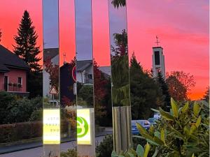 a group of three pictures of a sunset at Hotel Eikamper Höhe in Odenthal