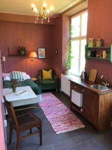 a kitchen with a sink and a living room at FärgLabbets Bed and Breakfast in Sunne +13 photos