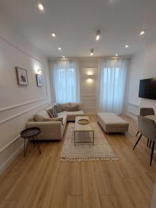 een woonkamer met een bank en een tafel bij Saint Raphael's apartment, classé 3 étoiles in Saint-Raphaël