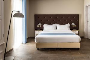 a bedroom with a large bed and a large window at The Segond Hotel in Xagħra