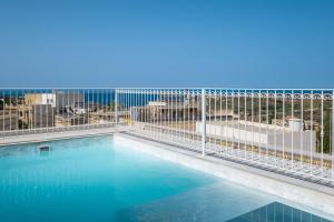 a swimming pool on the roof of a building at The Segond Hotel in Xagħra