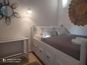 a bedroom with a bed with a mirror on the wall at Lampi's House in Patmos