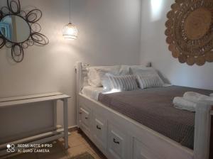 a bedroom with a bed with a mirror on the wall at Lampi's House in Patmos