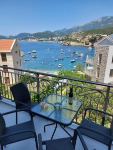a table and chairs on a balcony with a view of a river at Apartment Sara with seaview in Budva