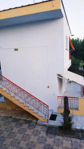 a building with stairs on the side of it at Filoxenia in Nea Irakleia