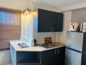 a kitchen with a sink and a refrigerator at 163 Bez Apartment 11 in Johannesburg