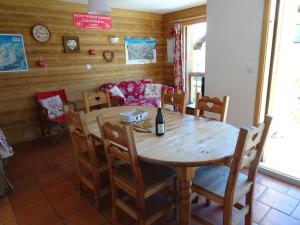 a dining room with a wooden table and chairs at Chalet La Ruche in Saint-Sorlin-dʼArves