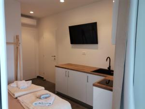 a kitchen with two towels on a counter and a sink at Mia & Ante Apartman in Tučepi