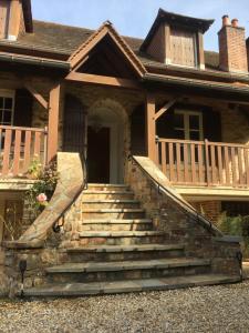 a house with stairs leading to the front door at Ground floor stylish french holiday home in Arnac-Pompadour