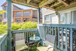 a balcony with a table and chairs and a house at Blue Mountain Luxury Studio in Blue Mountains