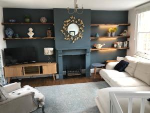 a living room with a couch and a tv at Clerks Cottage in Upton upon Severn