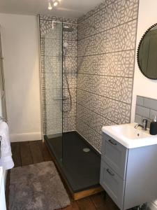 a bathroom with a shower and a sink at Clerks Cottage in Upton upon Severn +14 photos